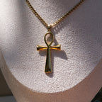 Gold necklace with an ankh pendant displayed on a mannequin bust.