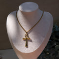 Gold necklace with an ankh pendant displayed on a mannequin bust.