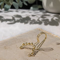 This is a gold-toned faux lip ring made with light gold copper wire. The wire design spirals into two diagonal directions, forming five tightly moulded circles.